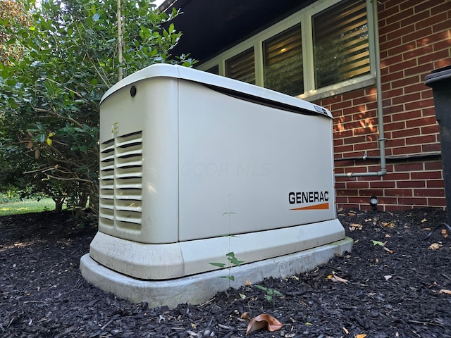 details featuring brick siding and a power unit