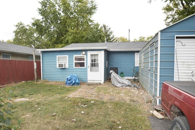 back of property featuring washer / clothes dryer and a yard