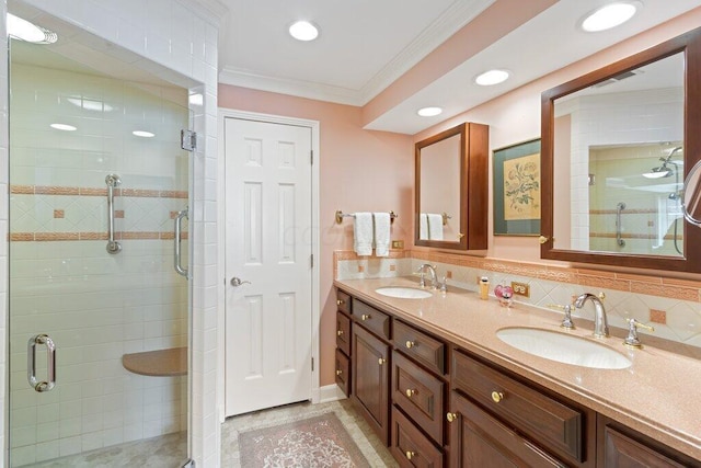 bathroom featuring vanity, an enclosed shower, crown molding, and tasteful backsplash