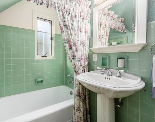 bathroom featuring tasteful backsplash and tile walls