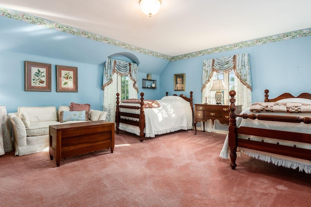 bedroom with carpet, lofted ceiling, and multiple windows