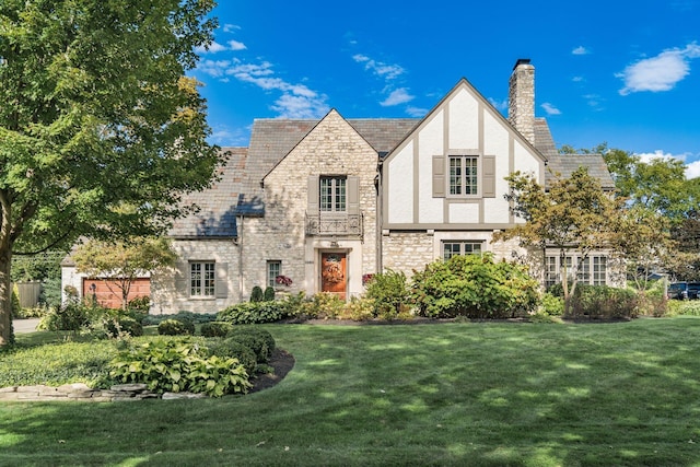 tudor home featuring a front yard