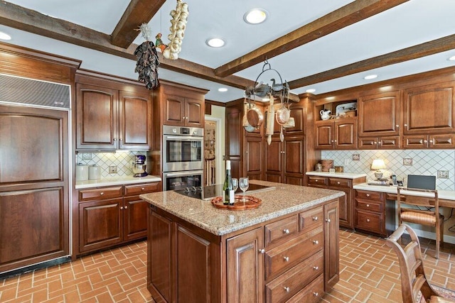 kitchen with beam ceiling, a center island, tasteful backsplash, and stainless steel double oven