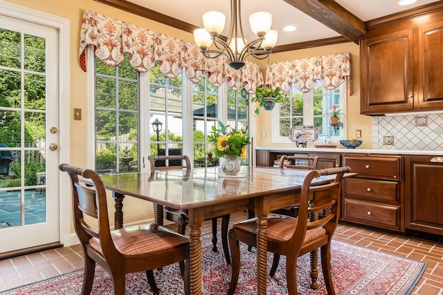 dining room featuring a chandelier, beam ceiling, plenty of natural light, and ornamental molding