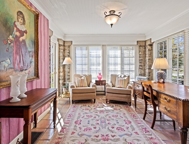 living area featuring baseboard heating, a wealth of natural light, and light tile patterned floors