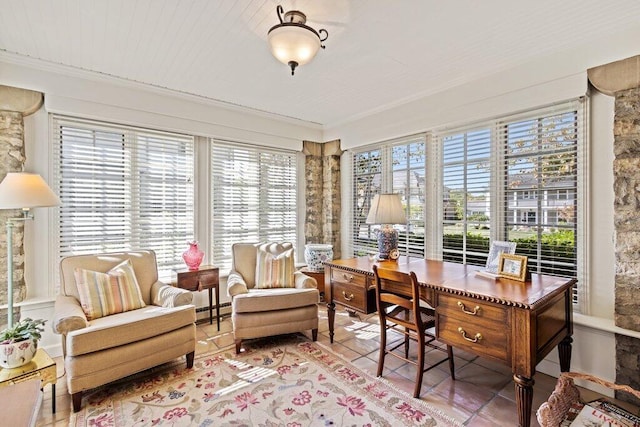 sunroom / solarium with a baseboard heating unit