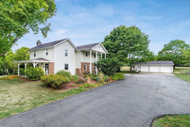 5595 Lancaster Rd, Hebron, OH 43025 - view of front of house featuring a garage, a front lawn, and an outdoor structure