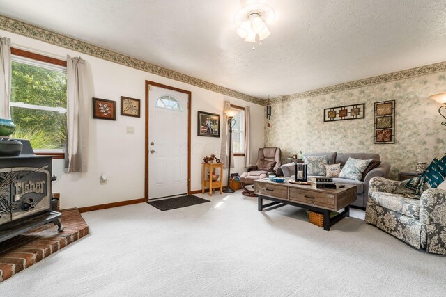 5595 Lancaster Rd, Hebron, OH 43025 - carpeted living room featuring a wood stove and a textured ceiling