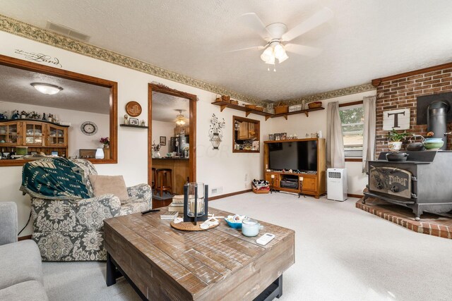 5595 Lancaster Rd, Hebron, OH 43025 - living room featuring carpet, a textured ceiling, and a wood stove