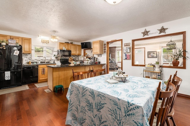 5595 Lancaster Rd, Hebron, OH 43025 - dining space with a textured ceiling, ceiling fan, sink, and dark hardwood / wood-style floors
