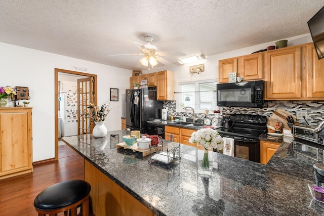5595 Lancaster Rd, Hebron, OH 43025 - kitchen with black appliances, dark hardwood / wood-style floors, sink, and tasteful backsplash