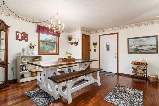 5595 Lancaster Rd, Hebron, OH 43025 - dining room featuring dark wood-type flooring, a textured ceiling, and a notable chandelier