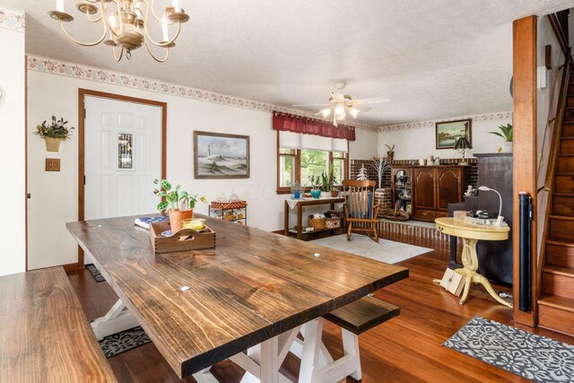 5595 Lancaster Rd, Hebron, OH 43025 - dining room featuring a textured ceiling, ceiling fan with notable chandelier, and dark wood-type flooring