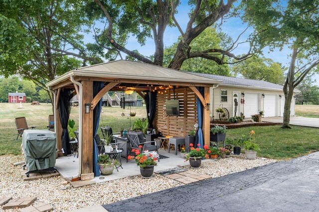 5595 Lancaster Rd, Hebron, OH 43025 - view of patio featuring a gazebo, a grill, and a garage