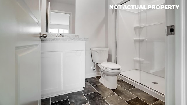 bathroom featuring vanity, toilet, and walk in shower