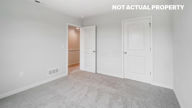 unfurnished bedroom featuring light colored carpet