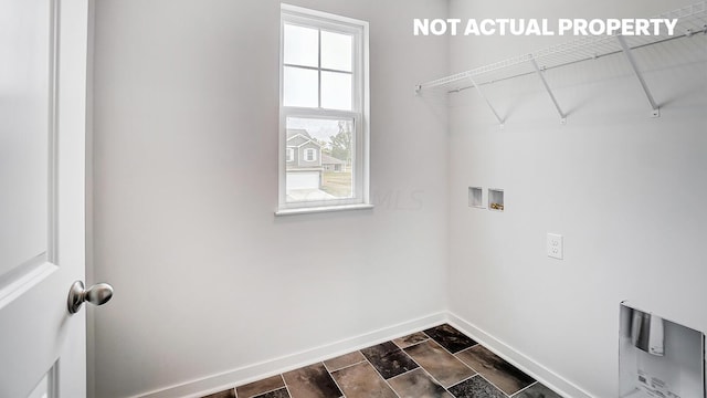 laundry area featuring washer hookup, plenty of natural light, and dark wood-type flooring