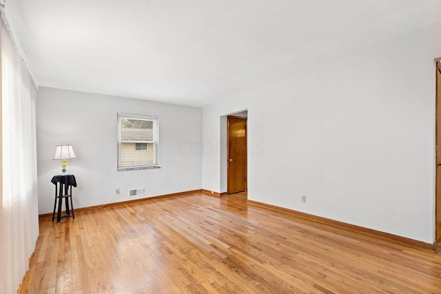 spare room with light hardwood / wood-style flooring