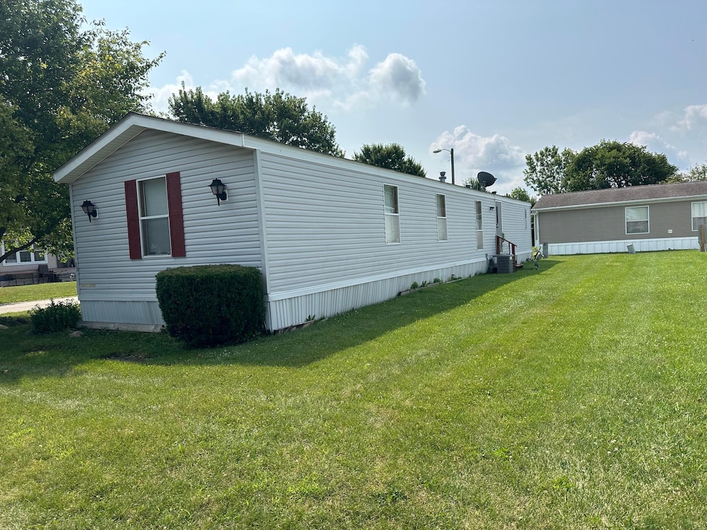 view of side of home with a yard