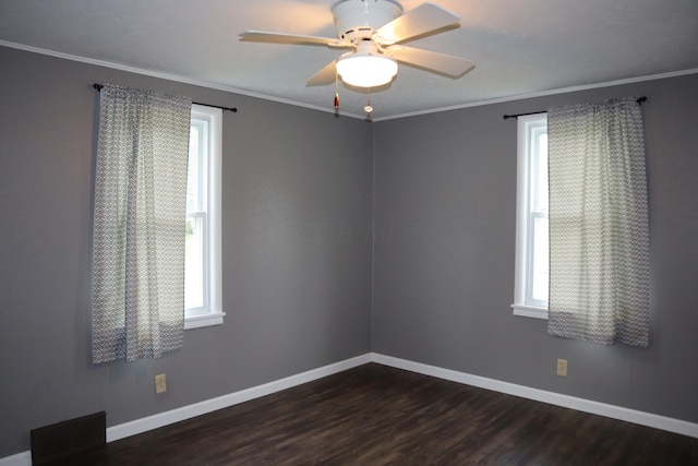 unfurnished room featuring dark hardwood / wood-style floors, a wealth of natural light, crown molding, and ceiling fan