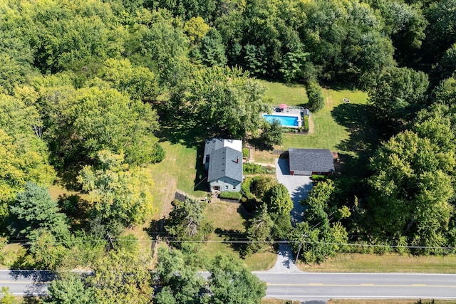 birds eye view of property featuring a view of trees