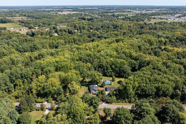 birds eye view of property featuring a wooded view