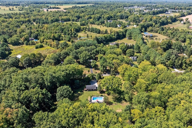 birds eye view of property featuring a wooded view