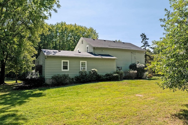 rear view of property with a yard