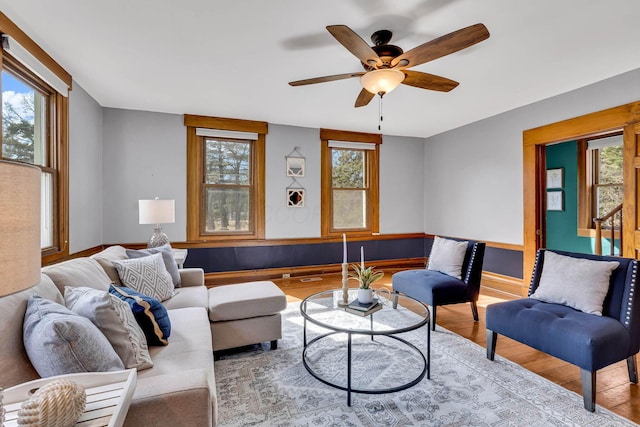 living room with a ceiling fan, baseboards, a wealth of natural light, and wood finished floors