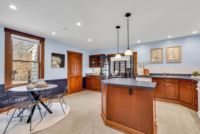 kitchen featuring dark countertops, light floors, recessed lighting, and a center island