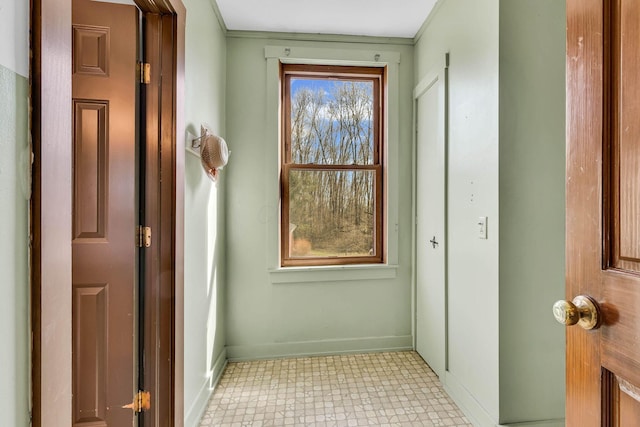 doorway to outside with baseboards