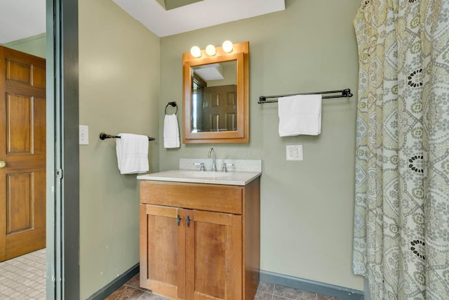 bathroom featuring a shower with shower curtain, tile patterned flooring, baseboards, and vanity