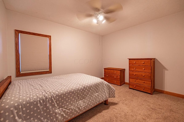 bedroom featuring ceiling fan and light carpet