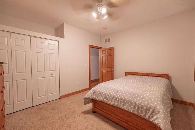 carpeted bedroom featuring a closet and ceiling fan