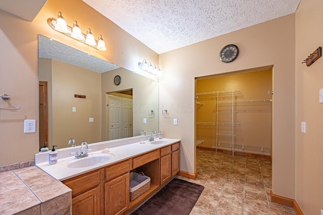 bathroom featuring vanity and a textured ceiling