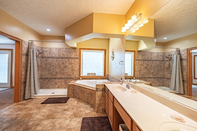 bathroom featuring plenty of natural light, vanity, and a textured ceiling