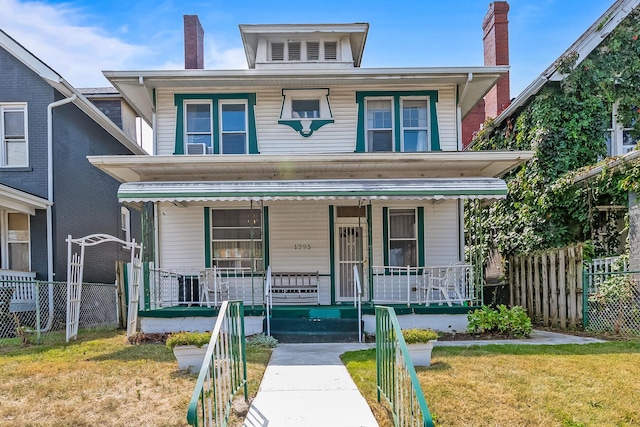 view of front of property with a porch and a front yard