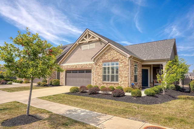 craftsman house featuring a garage and a front yard