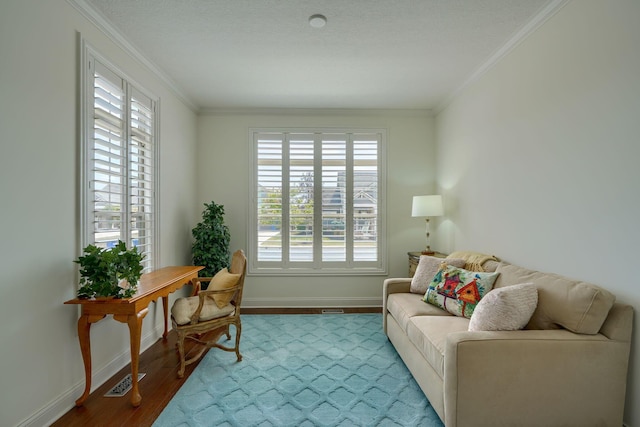 living area with wood-type flooring and ornamental molding