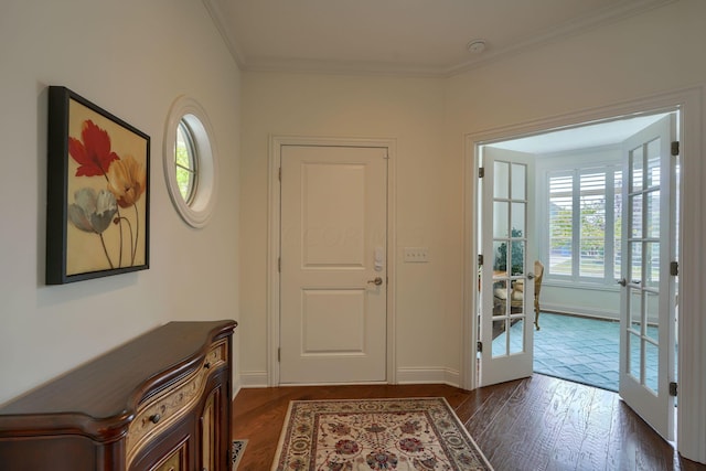 interior space featuring plenty of natural light, dark hardwood / wood-style flooring, ornamental molding, and french doors