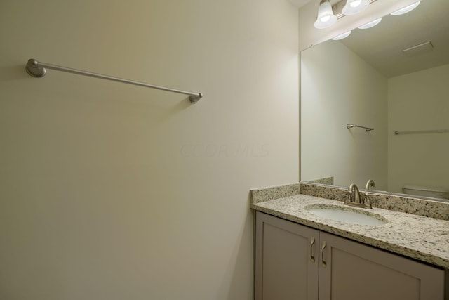 bathroom with vanity and toilet