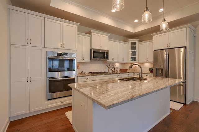 kitchen featuring decorative light fixtures, dark wood-type flooring, sink, and stainless steel appliances