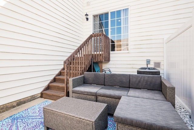 living area featuring stairs and wooden walls