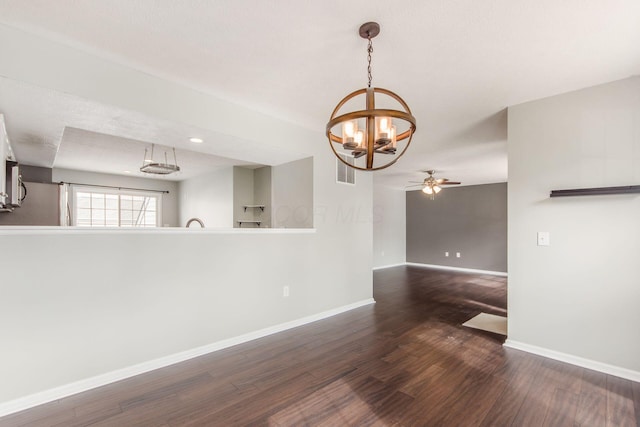 unfurnished room featuring ceiling fan, wood finished floors, visible vents, and baseboards