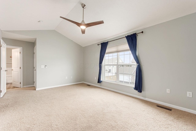 empty room with light carpet, baseboards, visible vents, a ceiling fan, and lofted ceiling