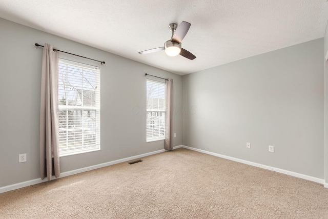 unfurnished room with ceiling fan, baseboards, and light colored carpet