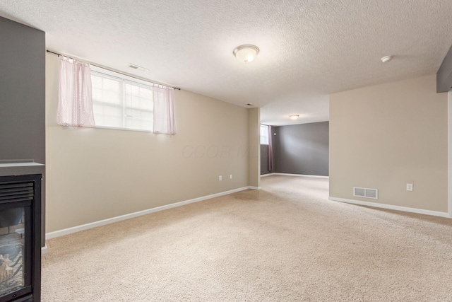 unfurnished living room with baseboards, visible vents, carpet flooring, and a multi sided fireplace