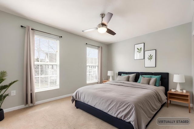 bedroom featuring baseboards, a ceiling fan, and light colored carpet