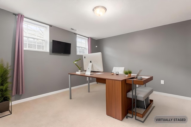 home office with light carpet, baseboards, and visible vents