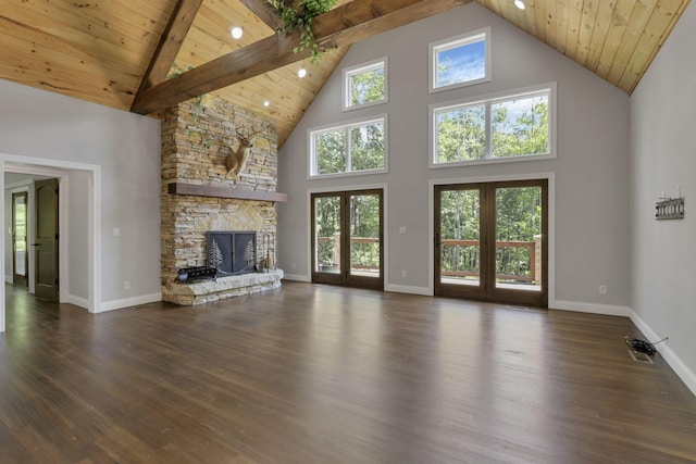 unfurnished living room featuring beamed ceiling, a healthy amount of sunlight, high vaulted ceiling, and dark wood-type flooring